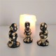 3 figuretes de Caganer en resina ceràmica gris amb acabat metall daurat
