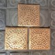 3 coasters Paris cobblestones in concrete, with gold colored metal finish
